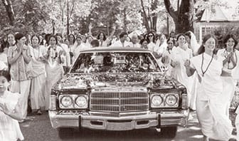 Limousine making its way through the throng of well-wishers.